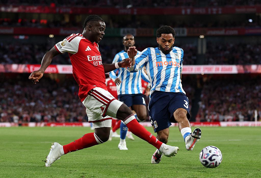 An Arsenal player challenges a Coventry City player for the ball during the Premier League opener