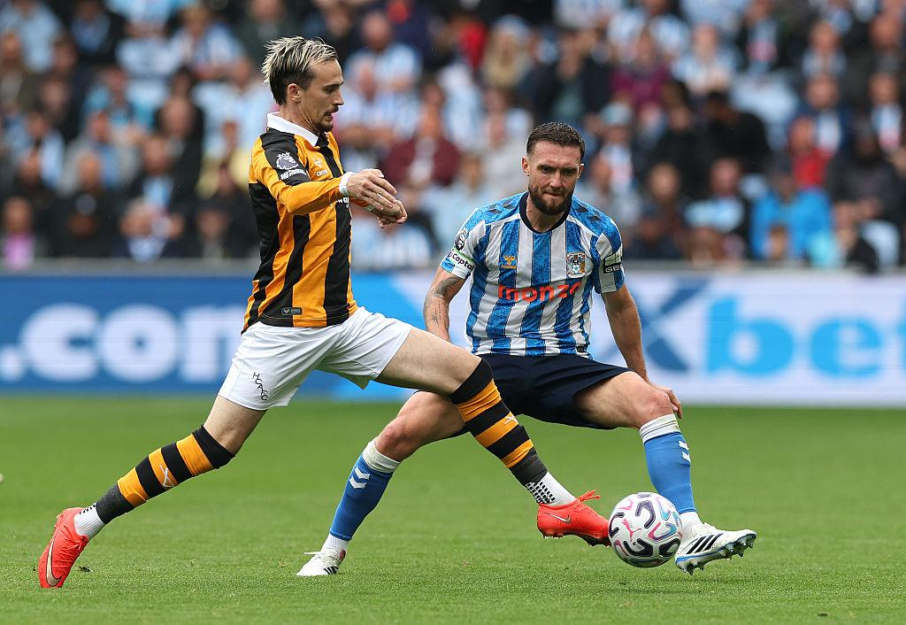 Hull City and Coventry City players contest the ball
