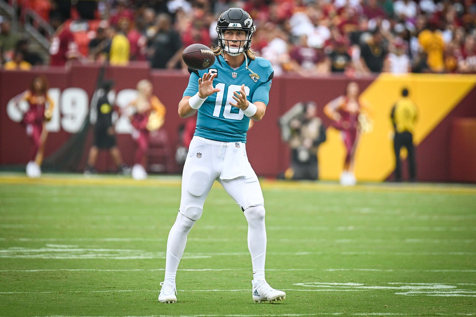 Trevor Lawrence takes a shotgun snap in a teal Jacksonville Jaguars uniform
