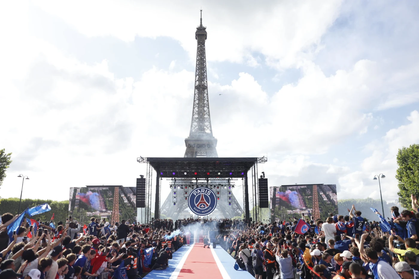Paris Saint-Germain celebrates with supporters near the Eiffel Tower