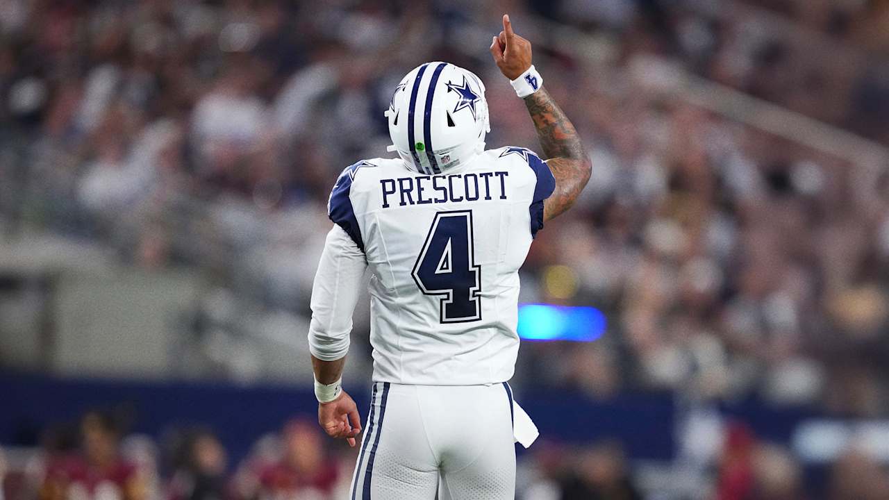 Dak Prescott raises his arm after a touchdown against the Commanders in Week 2