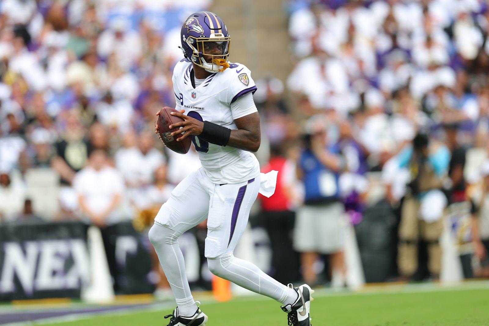 Lamar Jackson looks downfield with the ball against the Saints in Week 2