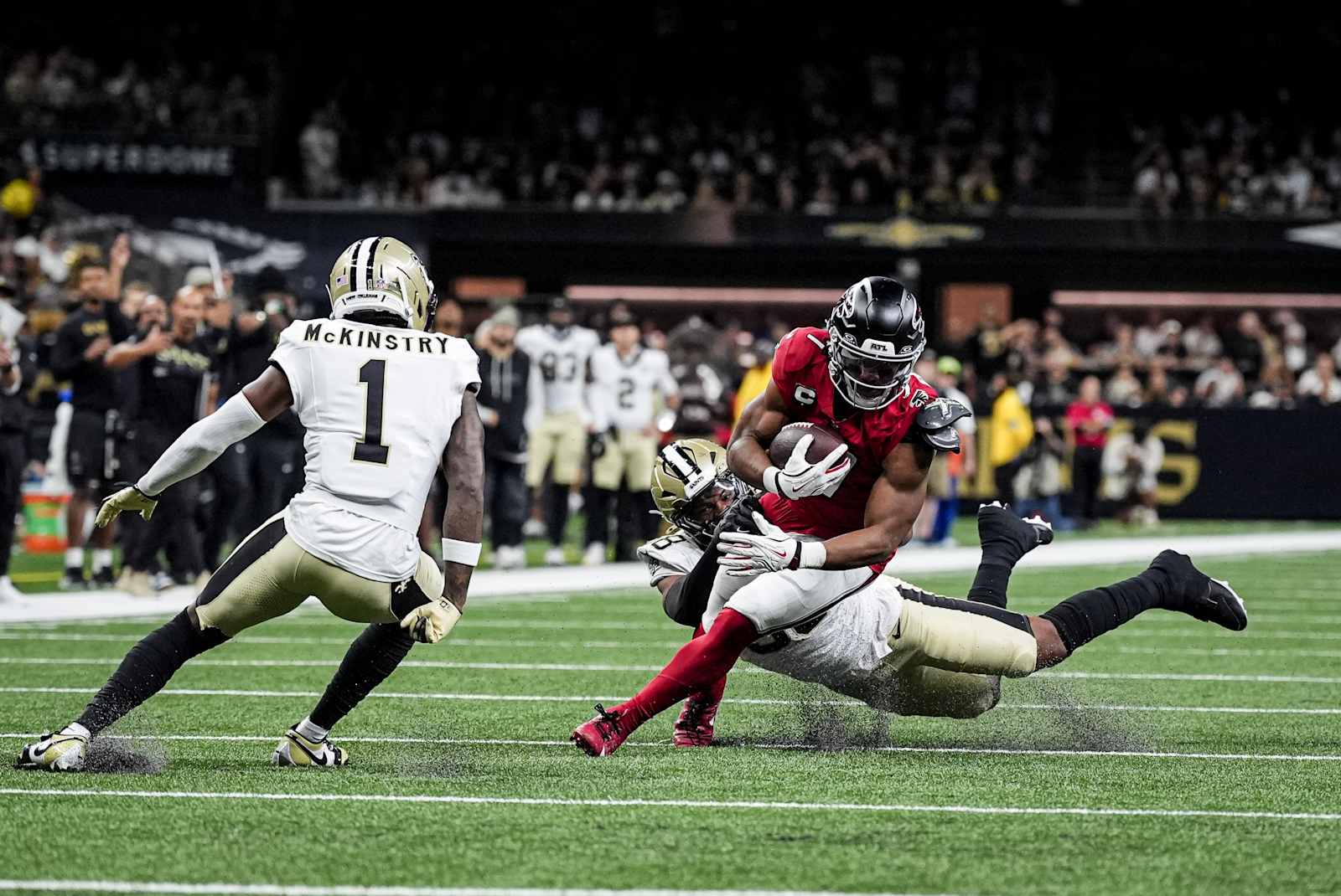 Bijan Robinson carries the ball through a tackle against New Orleans in Week 4