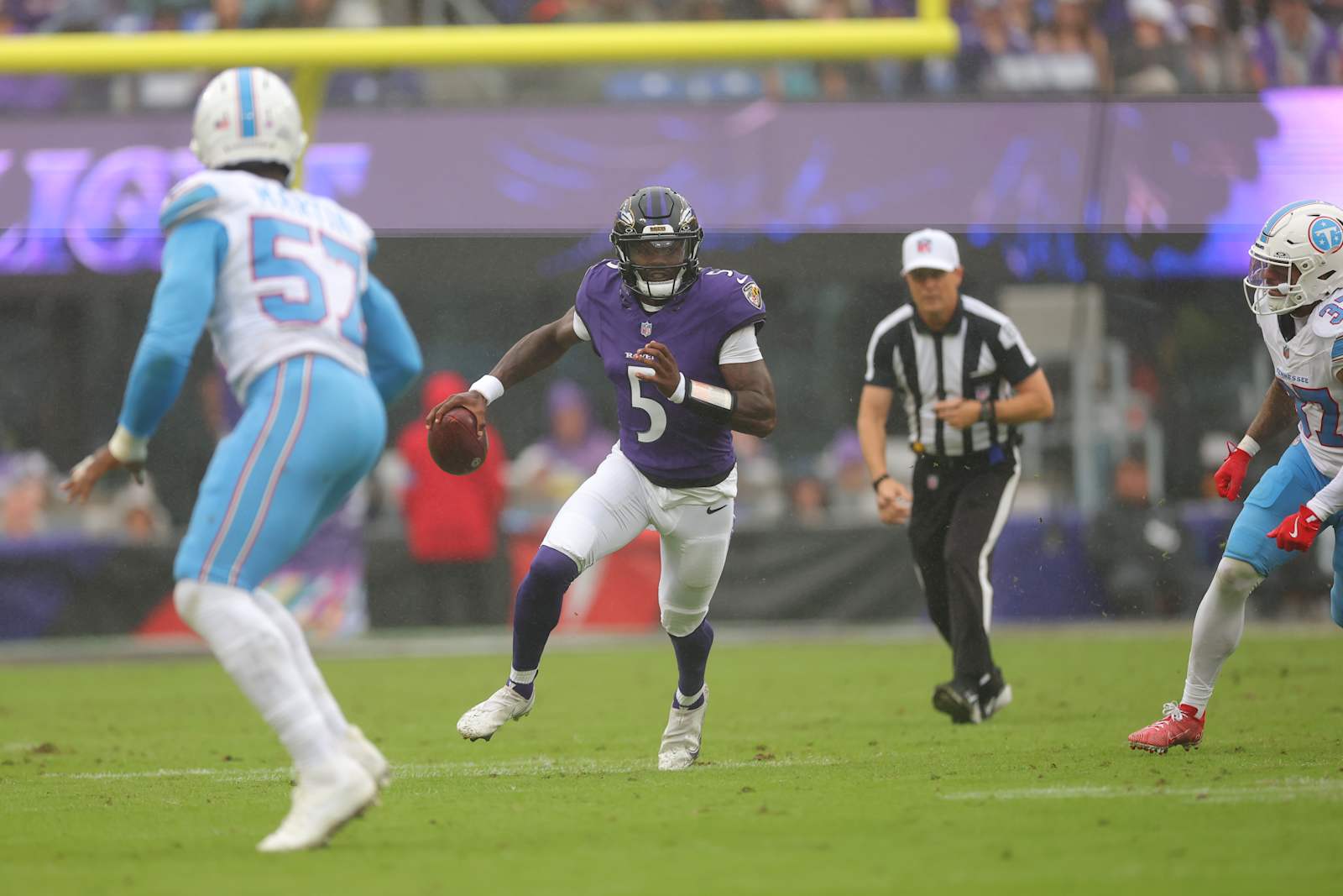 Tyler Huntley looks downfield while moving out of the pocket against Tennessee in Week 4