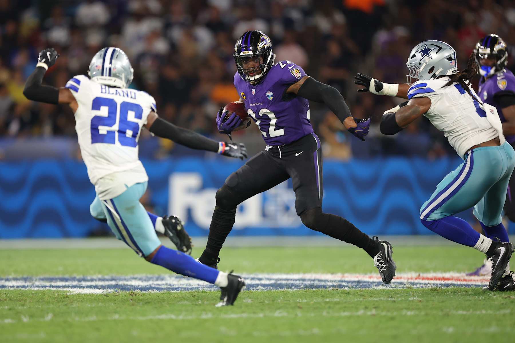 Derrick Henry runs between Cowboys defenders during the Ravens’ Week 3 win in Rio