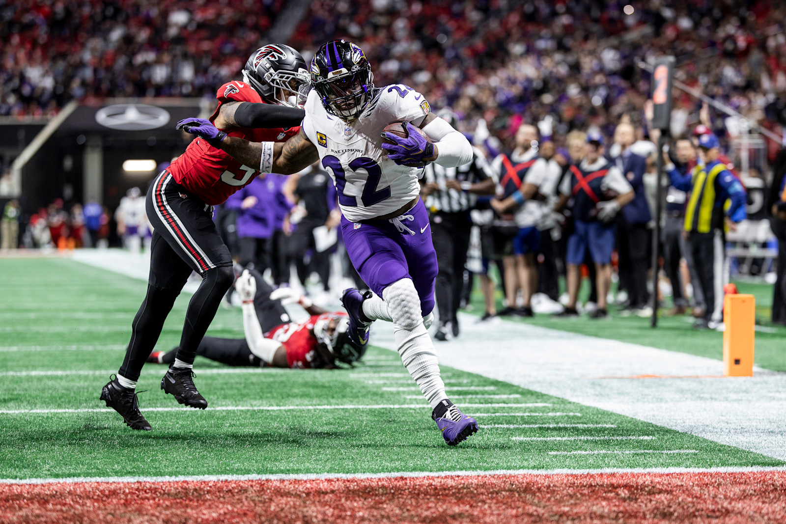 Derrick Henry carries the ball through an Atlanta tackle