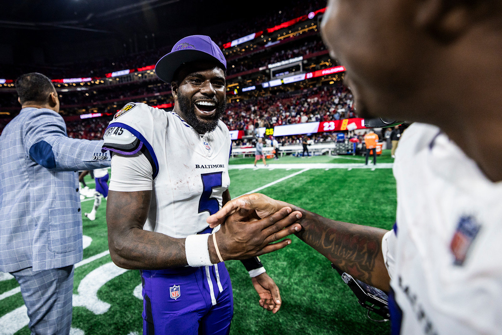Tyler Huntley smiles while greeting a teammate after the Ravens' overtime win in Atlanta