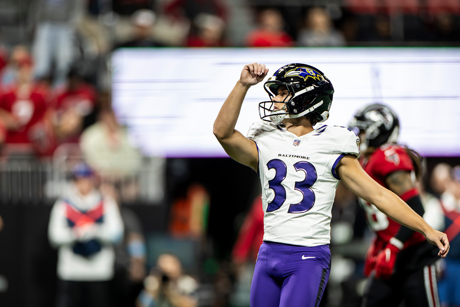 Tyler Loop follows through on a kick against the Falcons