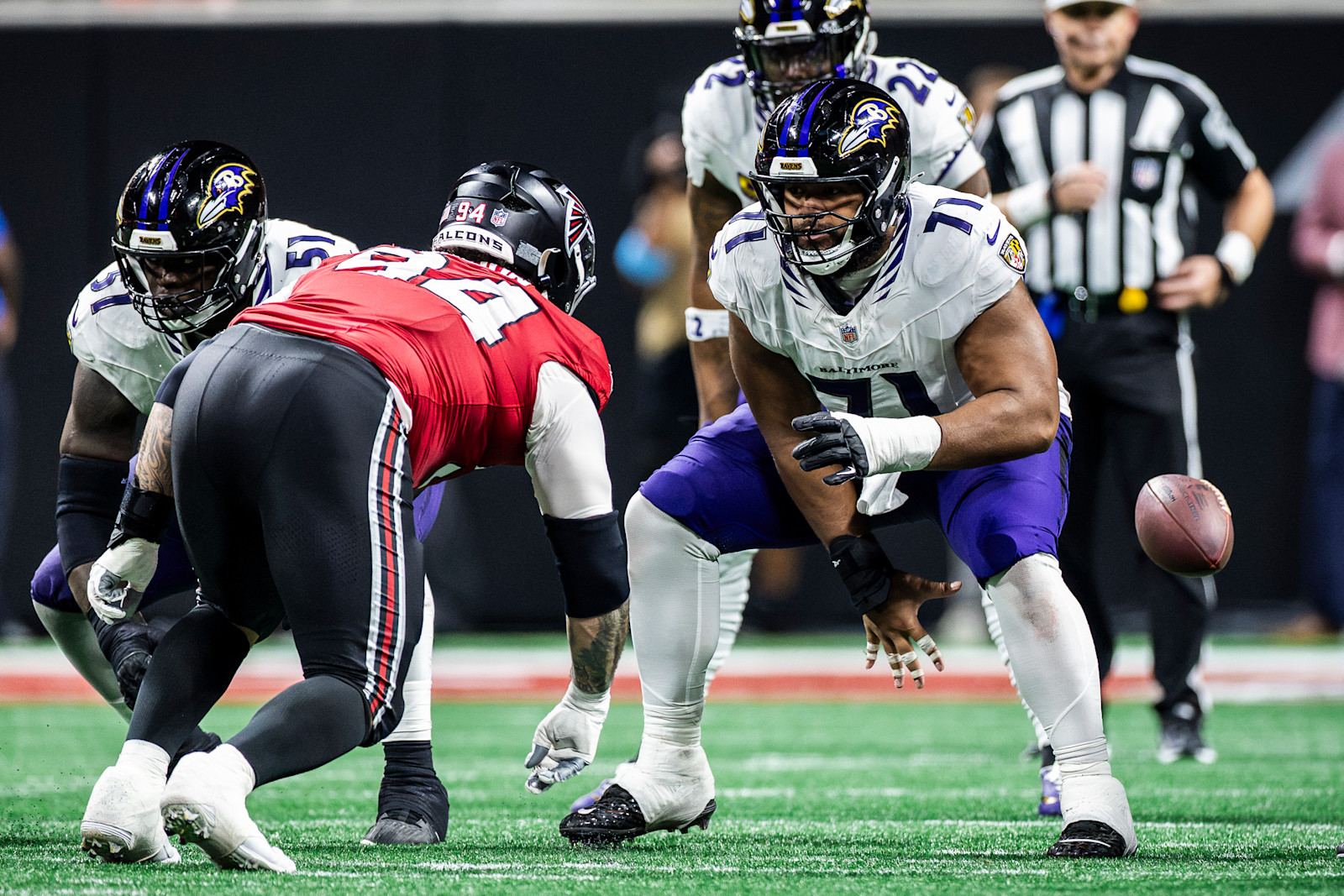 Vega Ioane snaps the ball to Tyler Huntley against Atlanta