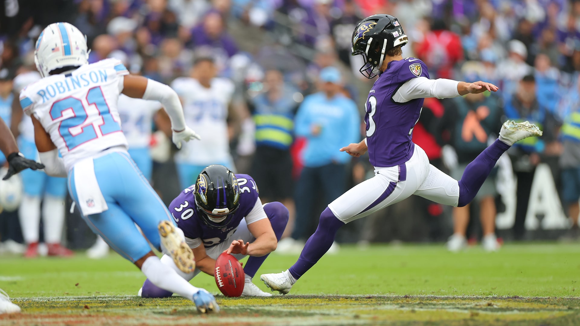 Tyler Loop kicks with Ryan Eckley holding during the Ravens' Week 4 game against the Titans