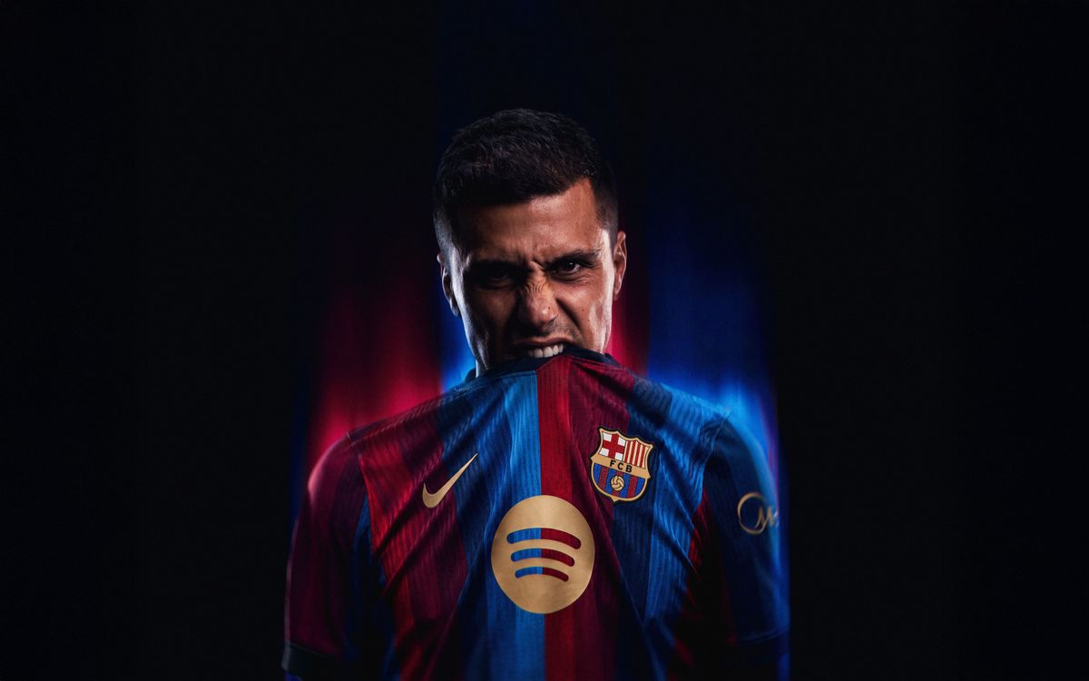 Rodri holds Barcelona's home shirt during his signing announcement