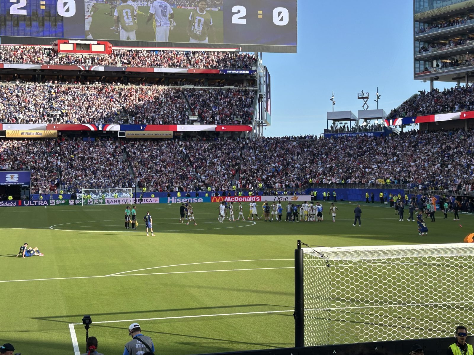 The scoreboard reads USA 2, Bosnia 0 at full time as the teams gather at midfield